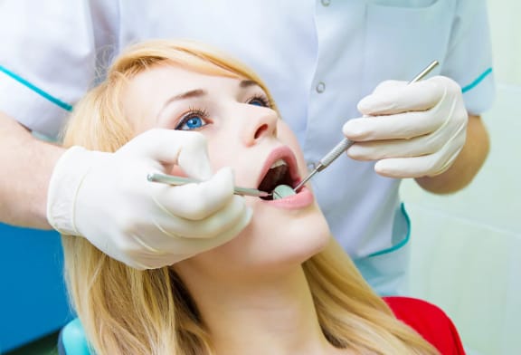 A child receiving a dental examination