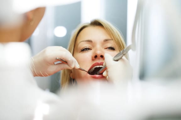 A dental provider examining a patient