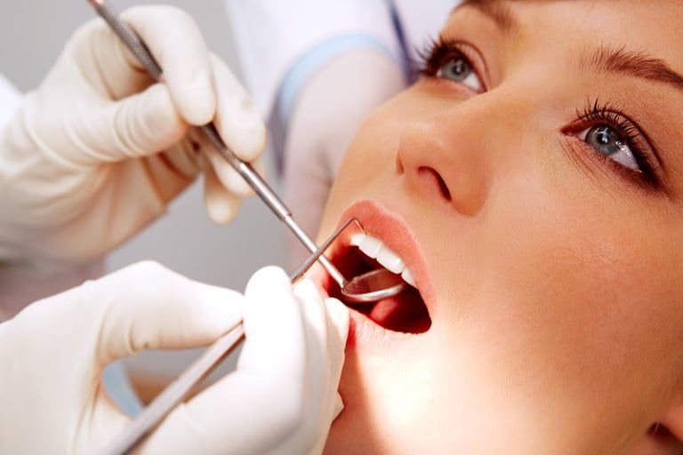 Patient receiving a periodontal examination