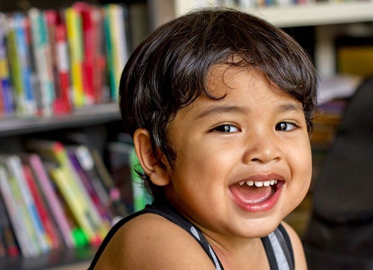 Child smiling with a restored tooth